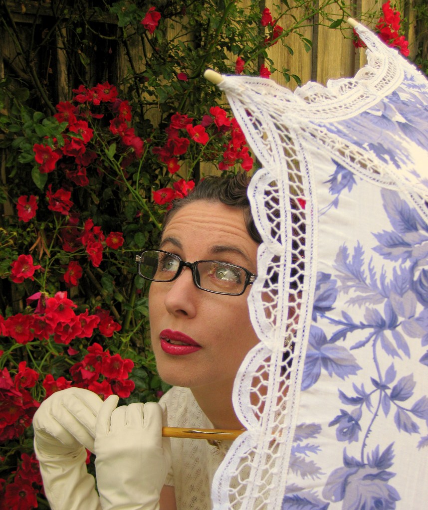 A headshot of Gail Carriger holding a parasol.